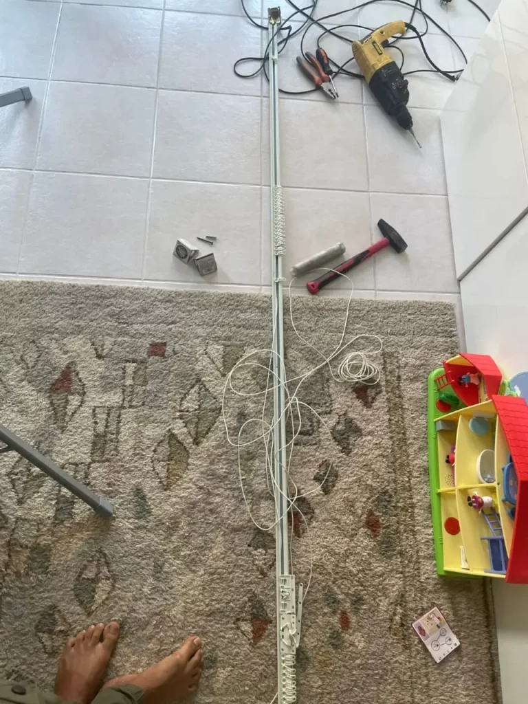 Handyman performing drilling work for curtain rail mounting